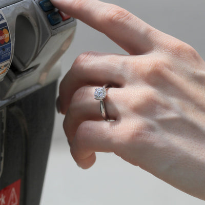 Hand wearing the Quiet Core Ring while  inserting a card into an ATM.
