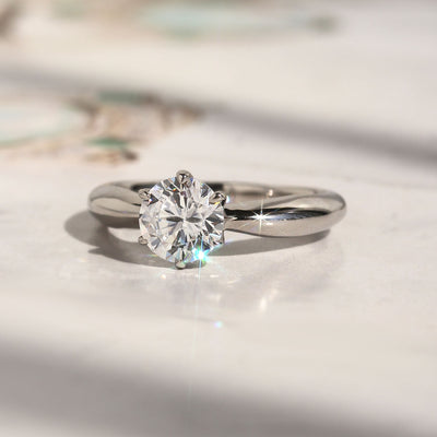 Side profile of solitaire ring showing 6-prong high setting and band taper