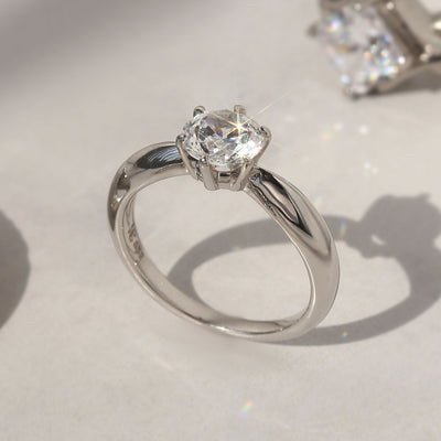 Side profile of solitaire ring showing 6-prong high setting and band taper