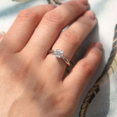 Close-up of a hand wearing the Still Worthy Solitaire Ring — a quiet, confident glow