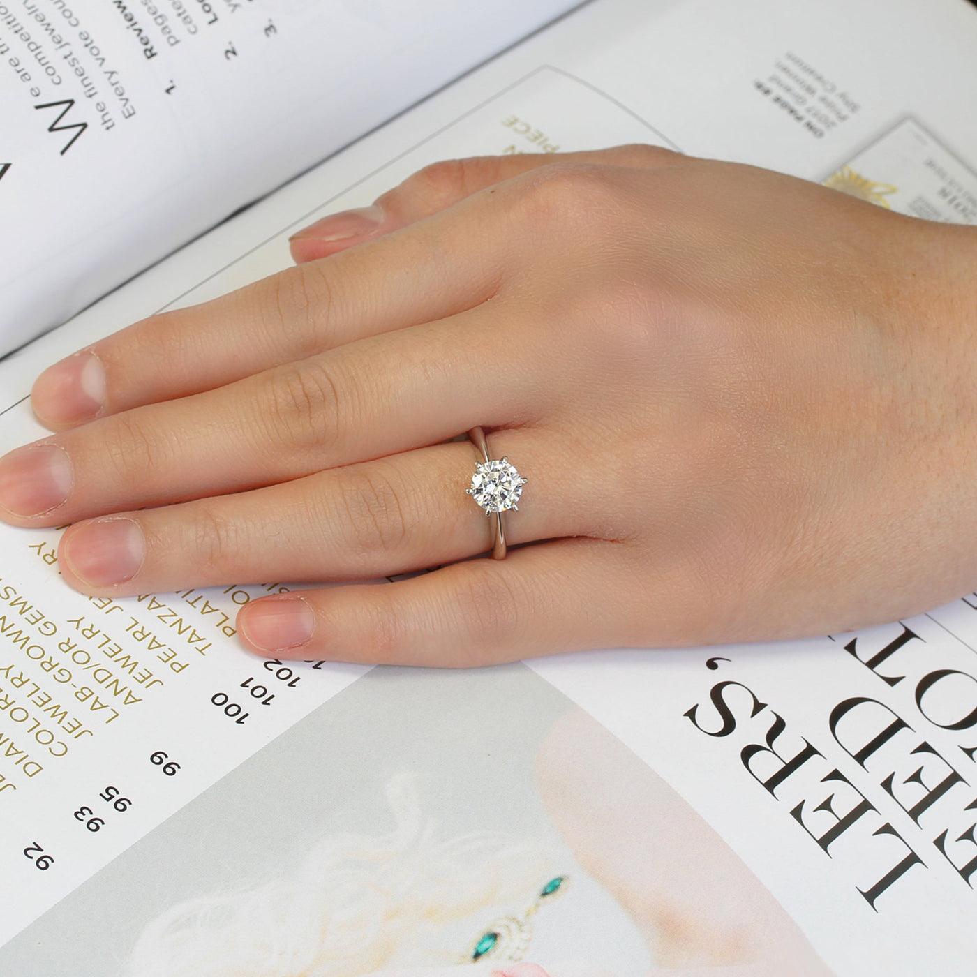 Hand wearing a Knife-edge platinum band – 5A CZ solitaire ring