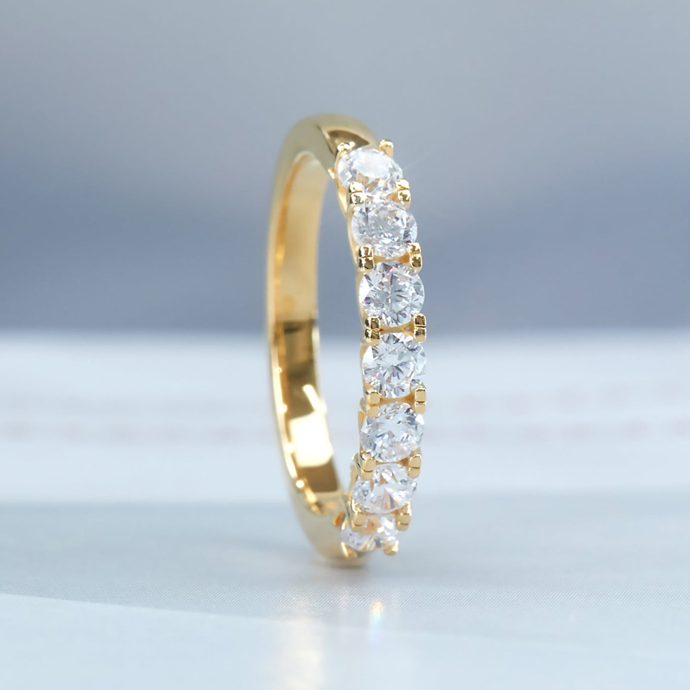 Seven Moments Ring with seven round stones in gold plated band.