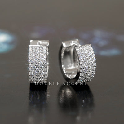 Five-row pave huggie hoop earrings shown in close-up lighting