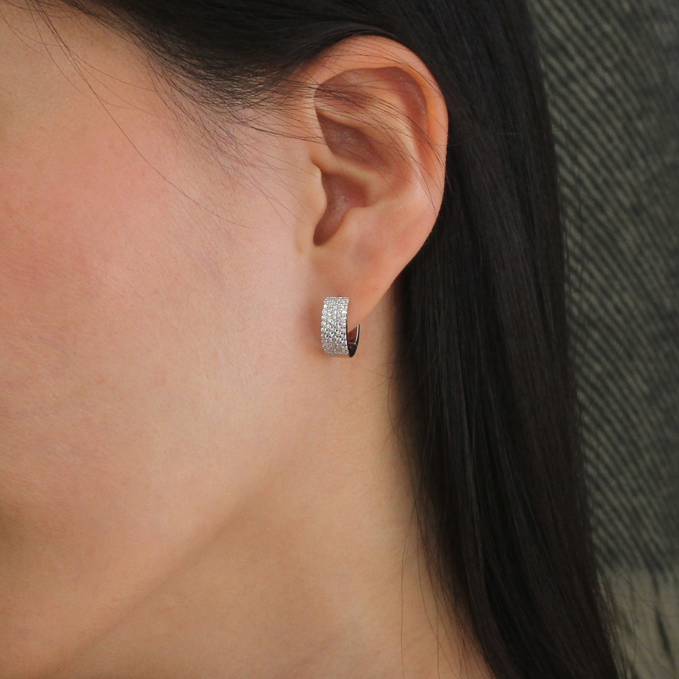 Wide sterling silver pave huggies with secure clasp design