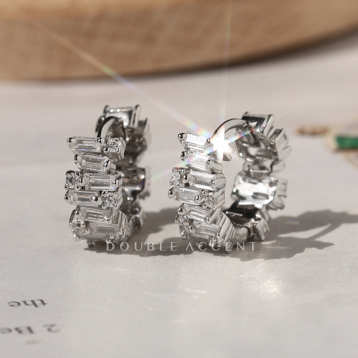 Luminous Stack Huggies in rhodium-plated sterling silver on display