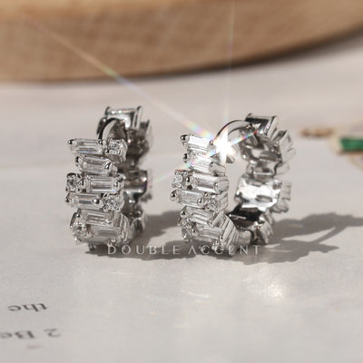 Luminous Stack Huggies in rhodium-plated sterling silver on display