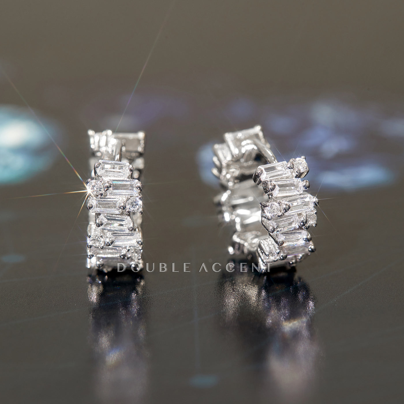 Luminous Stack Huggies in rhodium-plated sterling silver on display
