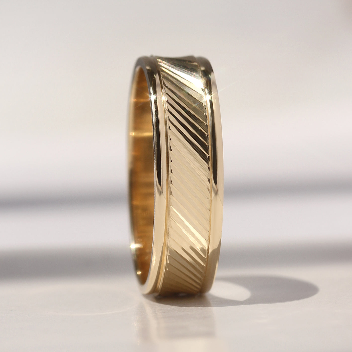 Goldrift Band Set — solid 14K gold couple rings with diamond-cut diagonal pattern and comfort-fit interior