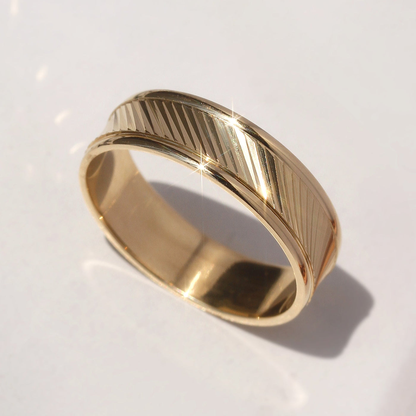 Goldrift Band Set — solid 14K gold couple rings with diamond-cut diagonal pattern and comfort-fit interior