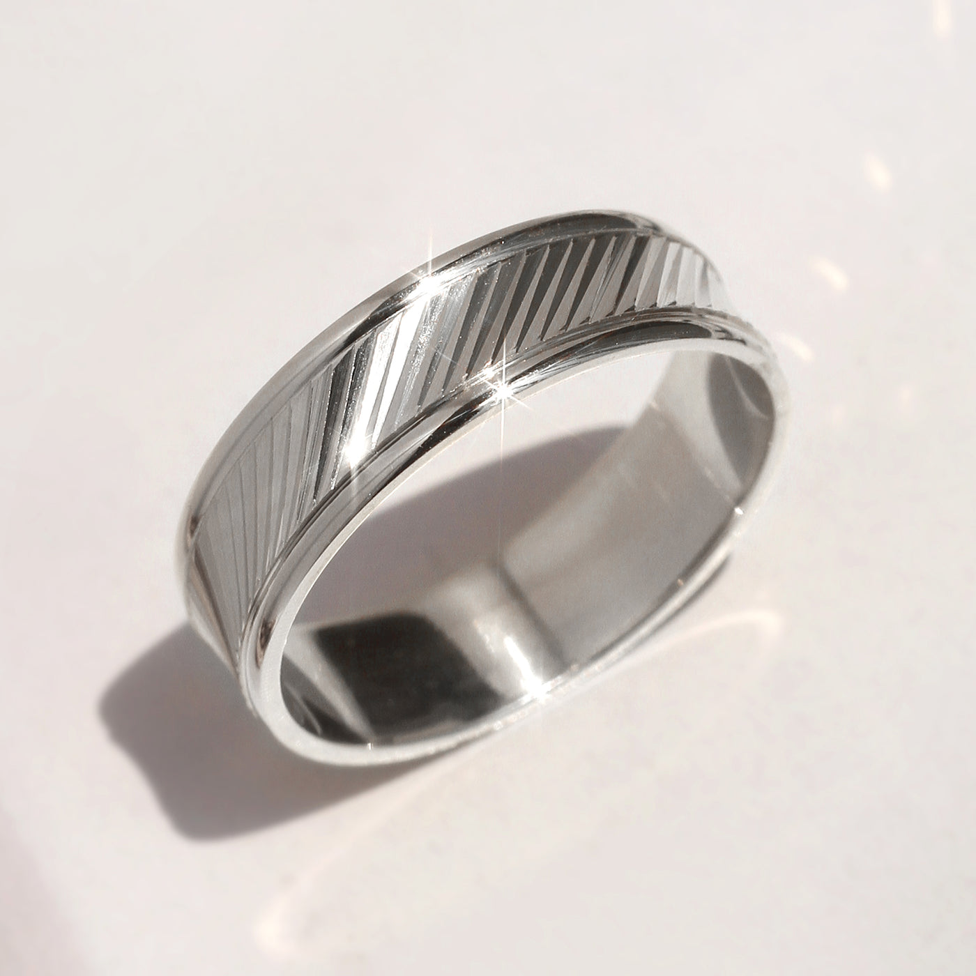 Goldrift Band Set — solid 14K white gold couple rings with diamond-cut diagonal pattern and comfort-fit interior