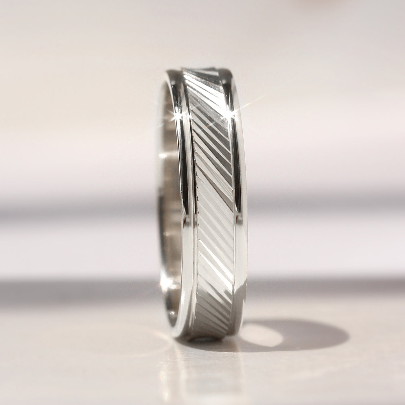 Goldrift Band Set — solid 14K white gold couple rings with diamond-cut diagonal pattern and comfort-fit interior