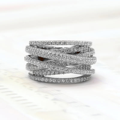 A close-up of Crosslight Ring – crisscross pave band in silver finishes symbolizing personal renewal.