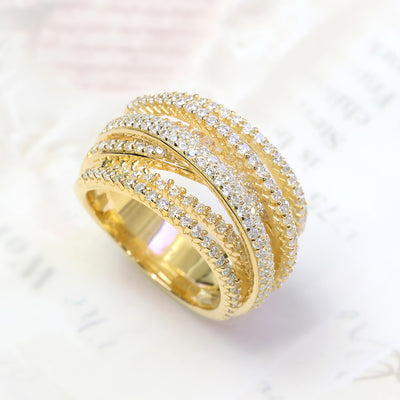A close-up of Crosslight Ring – crisscross pave band in gold finishes symbolizing personal renewal.