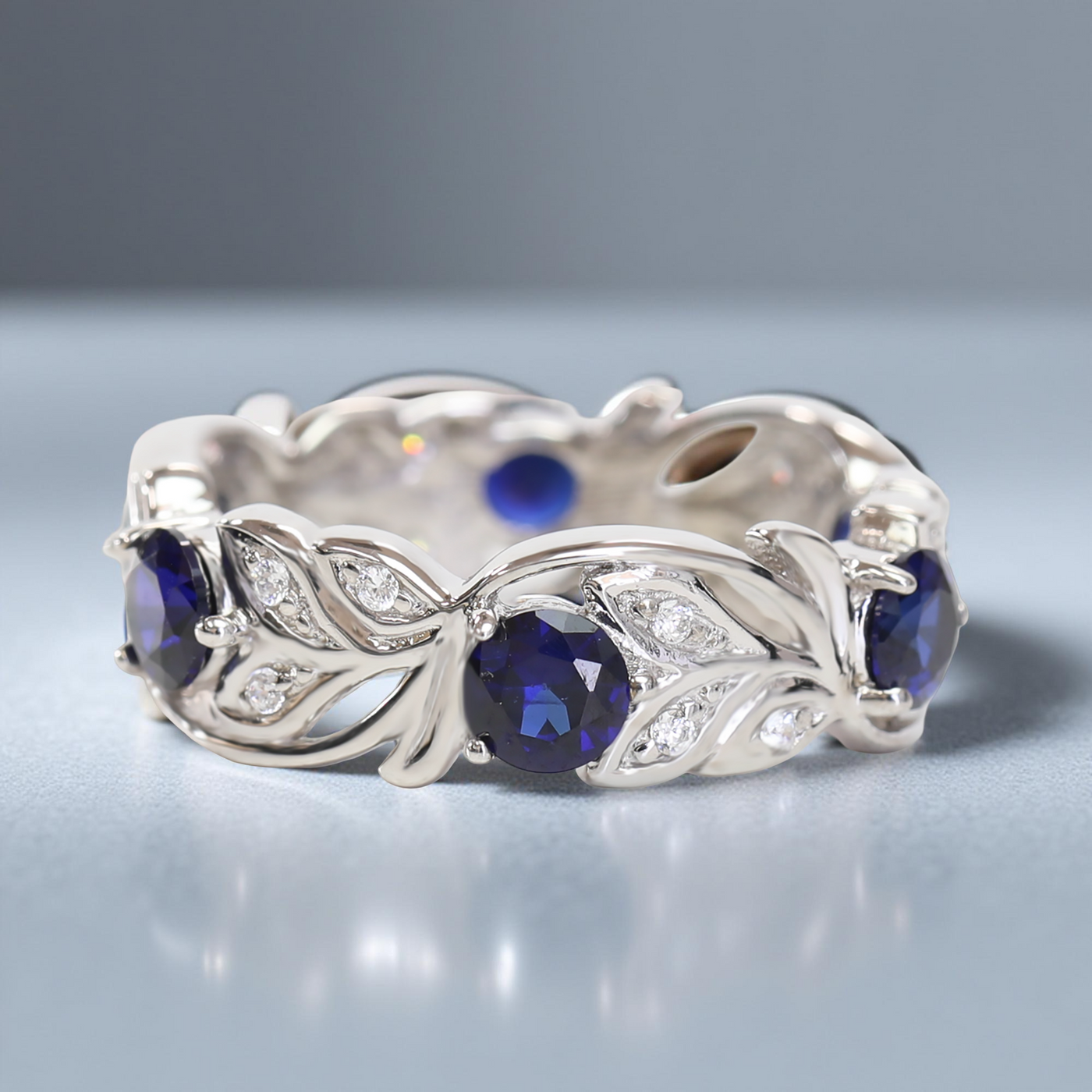Silver ring with blue gemstones on a gray background