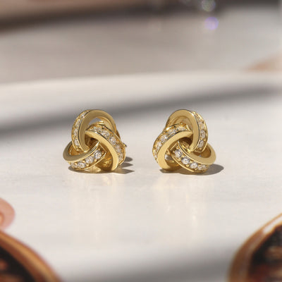 Promise Love Knot Stud Earrings in sterling silver with cubic zirconia stones, available in gold, rose gold, or rhodium finish.