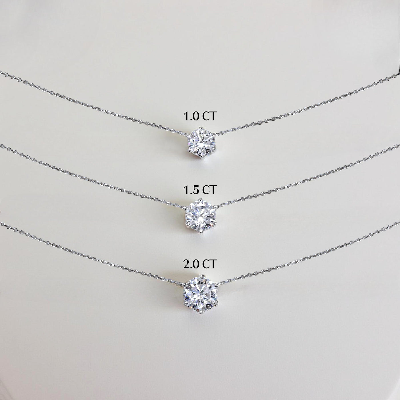 Close-up of six-prong CZ or moissanite stone on the Aura Solitaire Necklace.