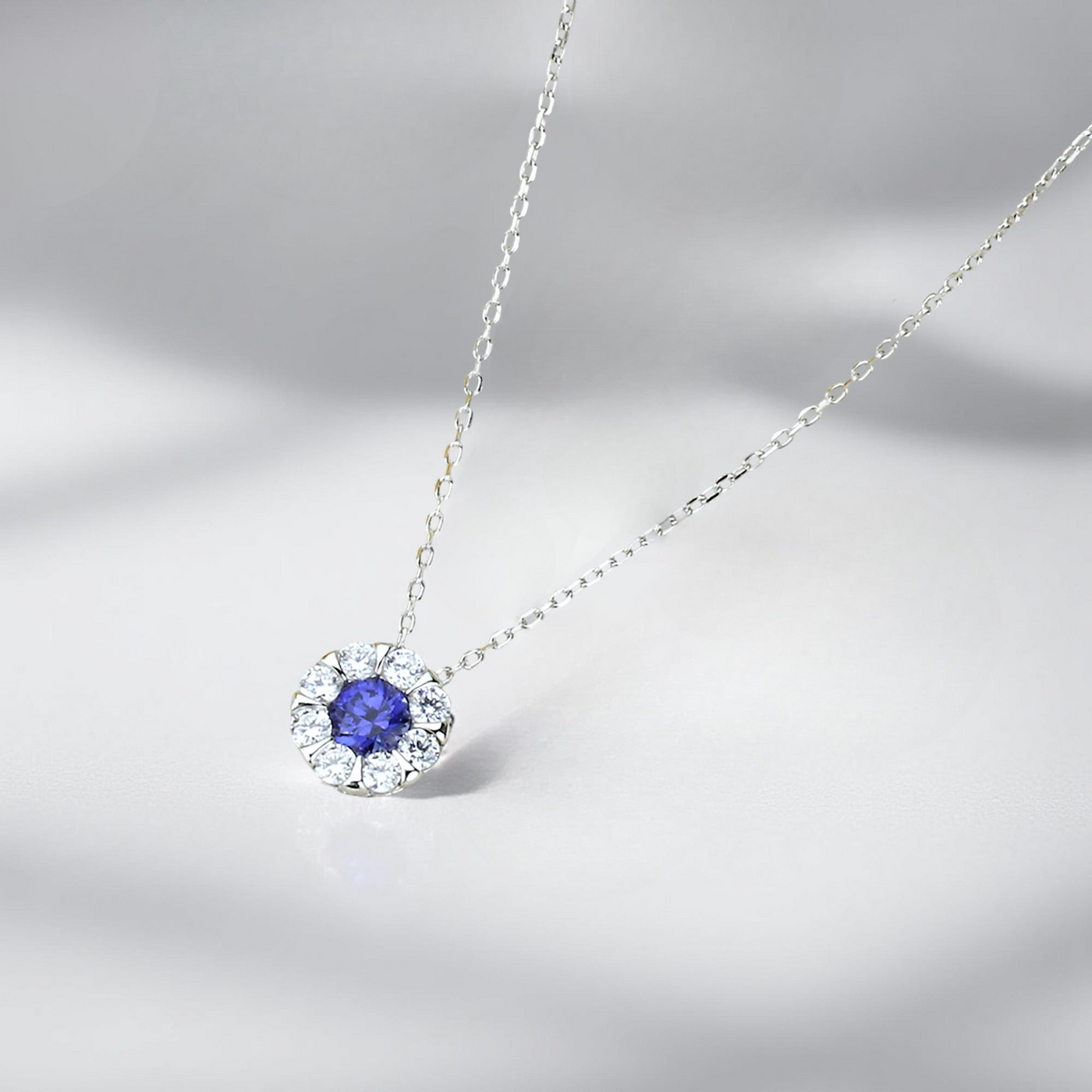 Platinum-plated sterling silver pendant necklace with blue sapphire color cubic zirconia cluster stones – Calm Mindfulness Jewelry Set