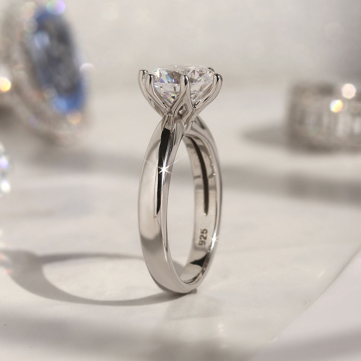 Next Light Solitaire Ring showing 6-prong flower-style setting and smooth taper band