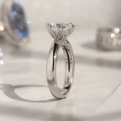 Next Light Solitaire Ring showing 6-prong flower-style setting and smooth taper band