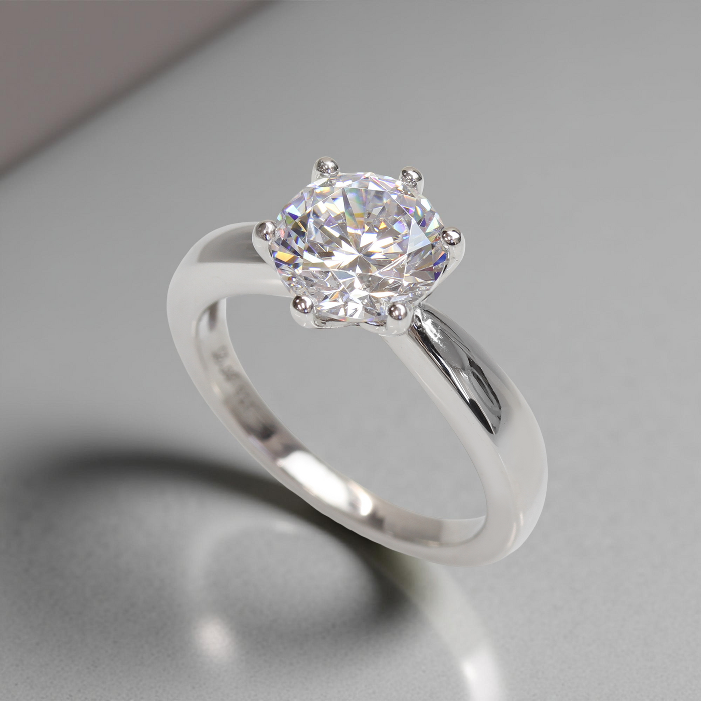 Side view of the Next Light Solitaire Ring – low-prong platinum setting with sparkling CZ
