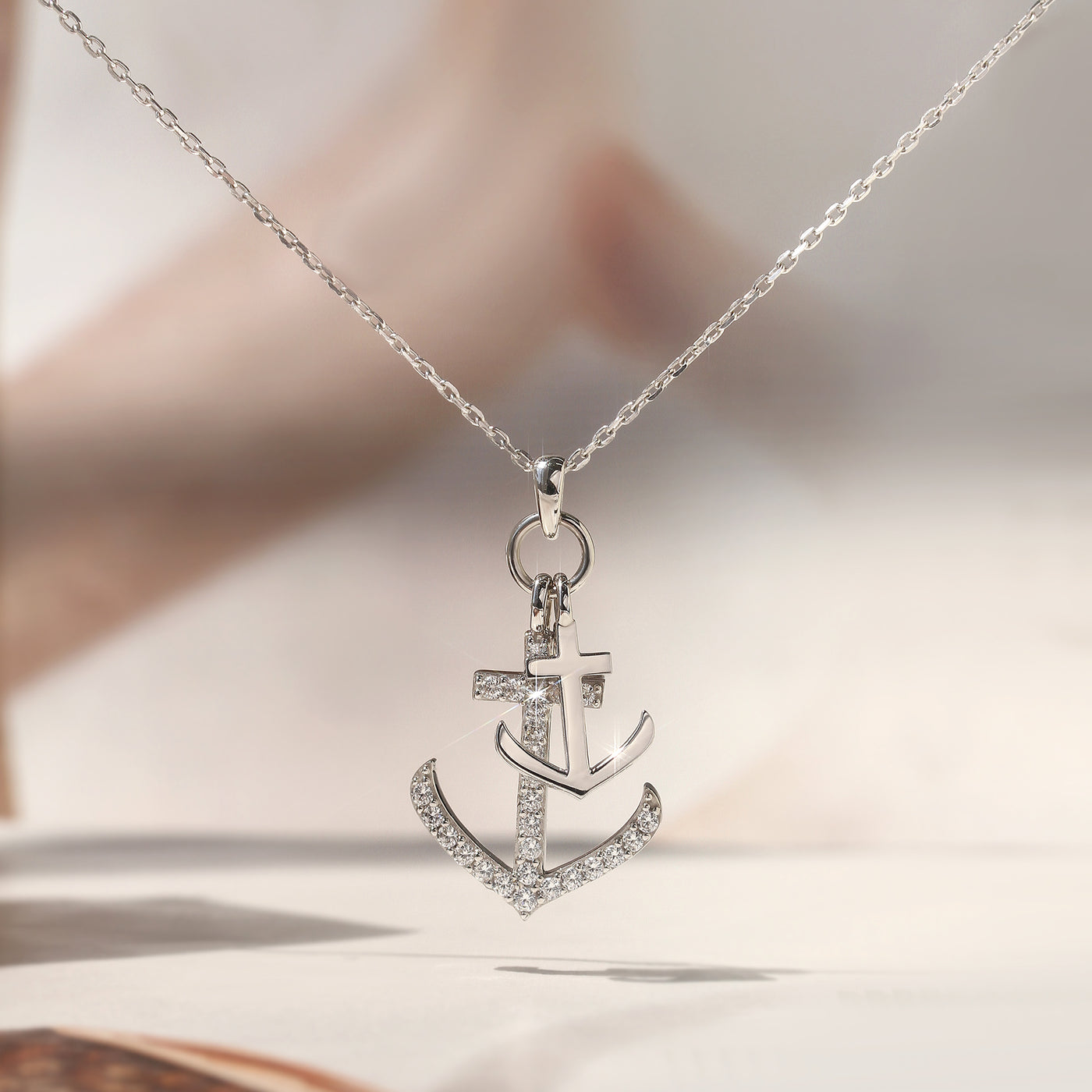 Silver anchor pendant necklace on a soft background