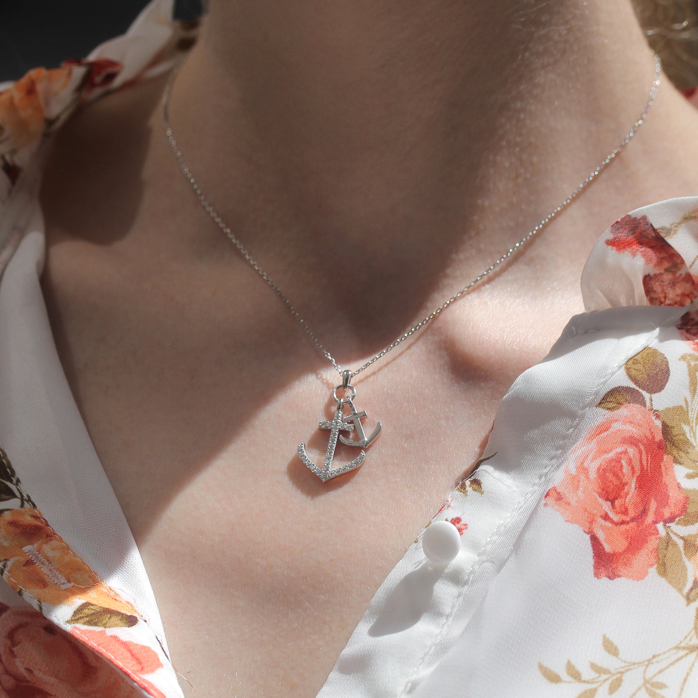 Person wearing dual anchor necklace in platinum finish