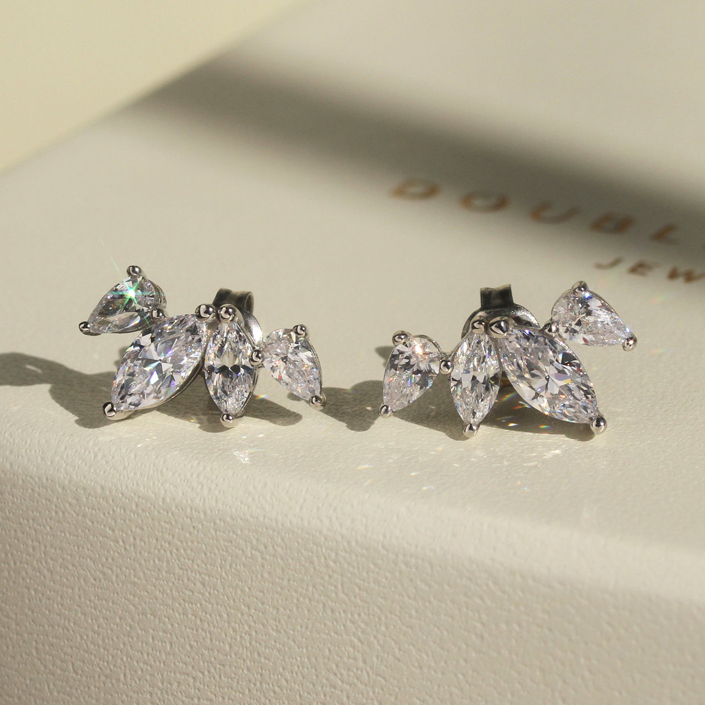 Close-up of necklace and earring set — marquise and teardrop floral design