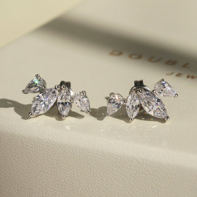 Close-up of necklace and earring set — marquise and teardrop floral design