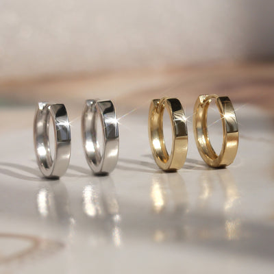 Side-by-side view of First Shine Huggie Hoops in full color variations