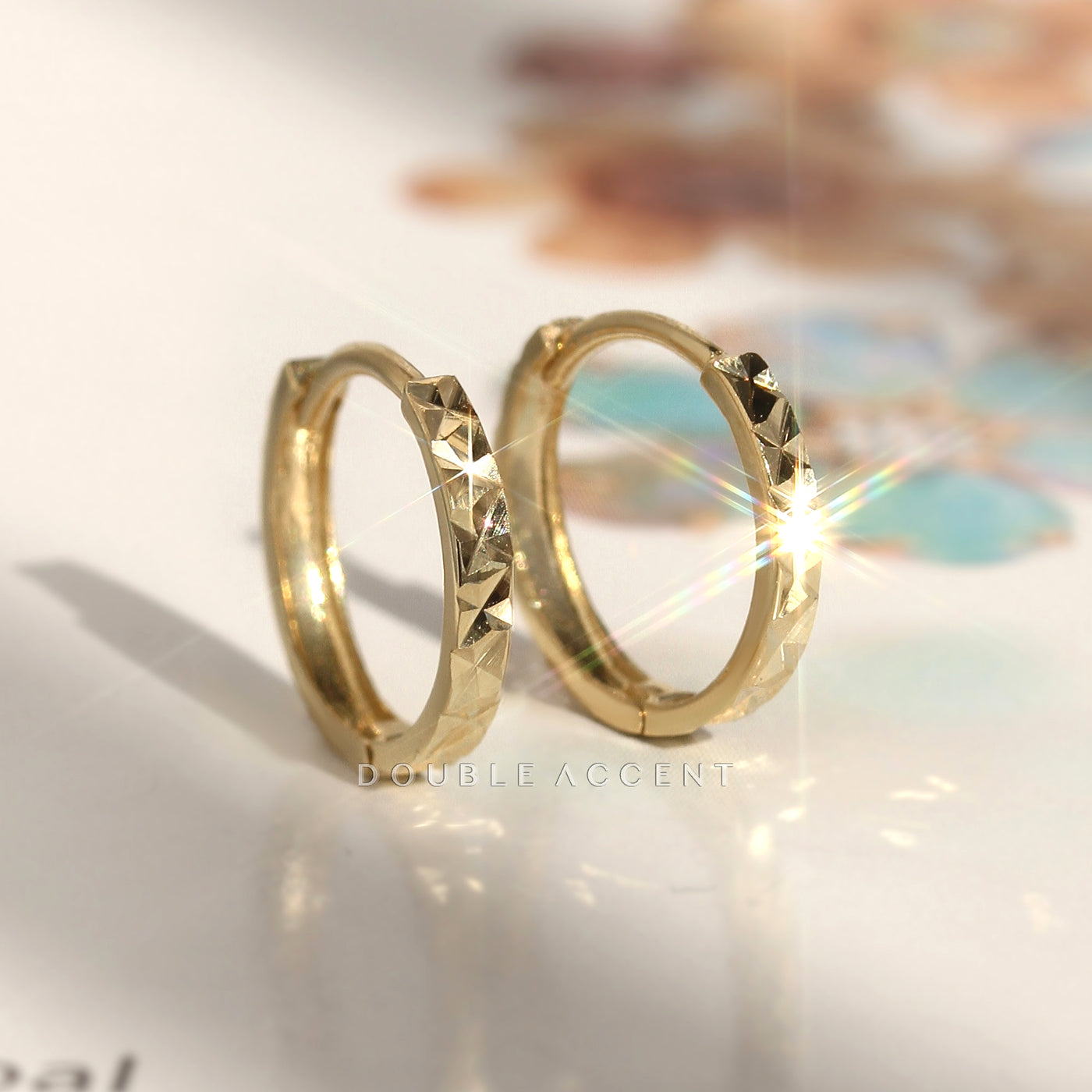 Close-up of Light Aura Huggies catching light