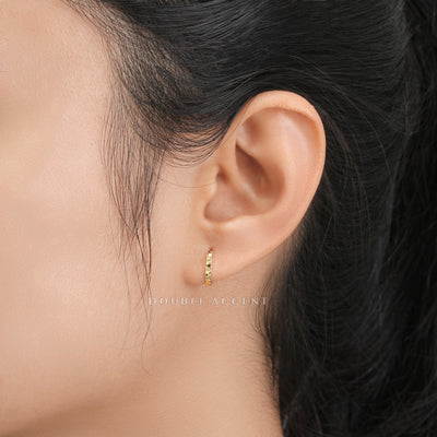 Close-up of Light Aura Huggies catching light