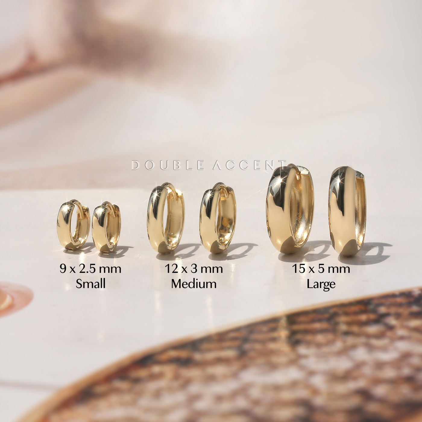 Dome profile and polished finish shown for each size variation of gold huggie earrings – Double Accent