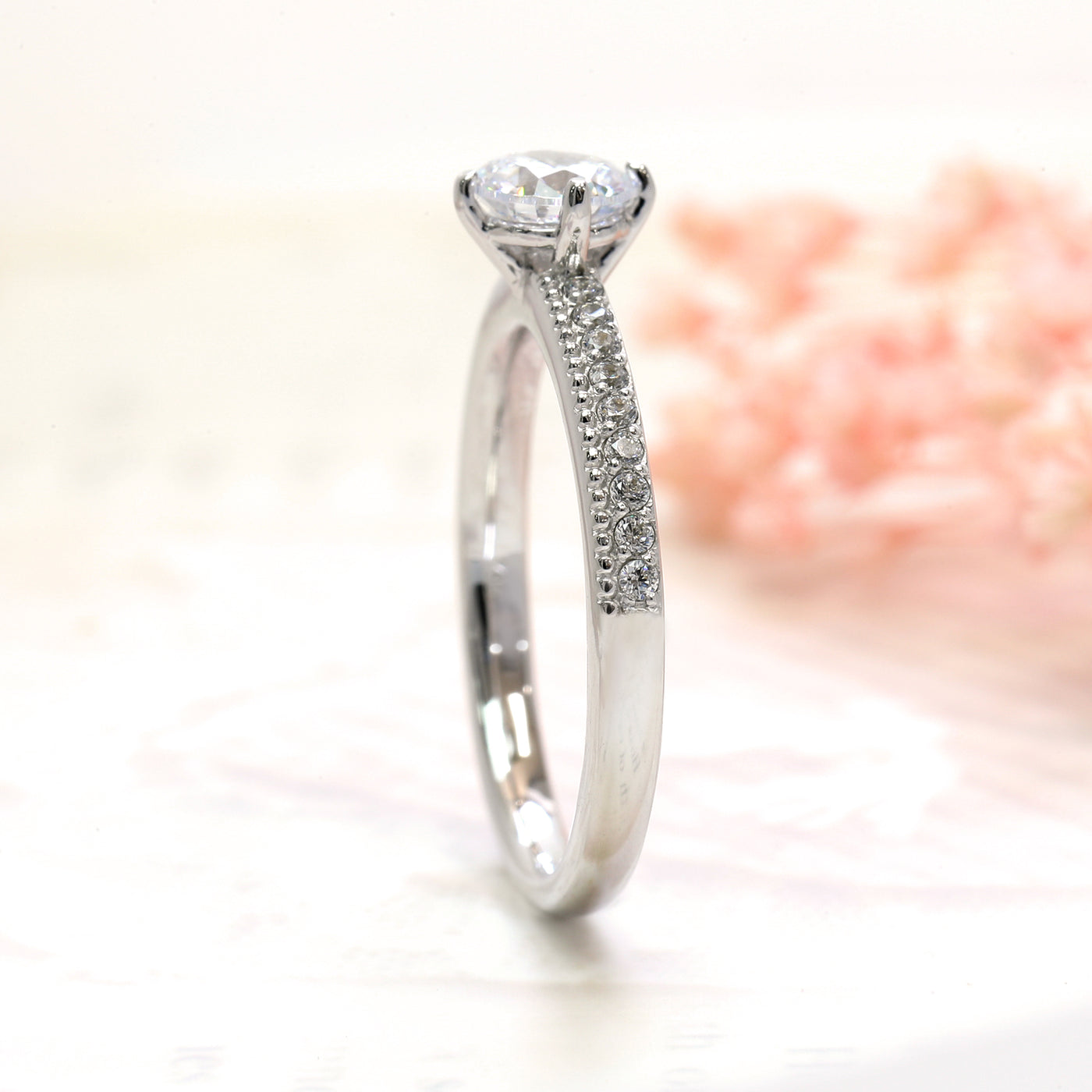Close-up of 4-prong center setting and pavé shank