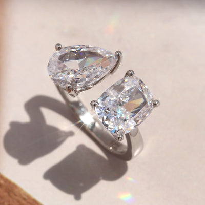 Connected Light Ring with pear and radiant CZ stones in platinum silver.