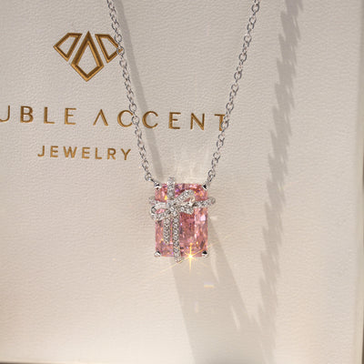Blush Gift Pendant — sterling silver necklace with pink diamond-tone CZ and ribbon-like detail, gift-ready presentation
