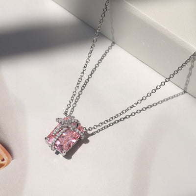 Blush Gift Pendant — sterling silver necklace with pink diamond-tone CZ and ribbon-like detail, gift-ready presentation