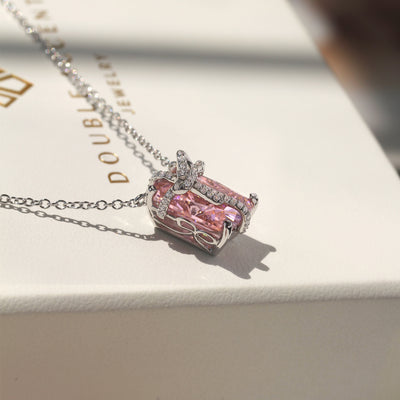 Blush Gift Pendant — sterling silver necklace with pink diamond-tone CZ and ribbon-like detail, gift-ready presentation