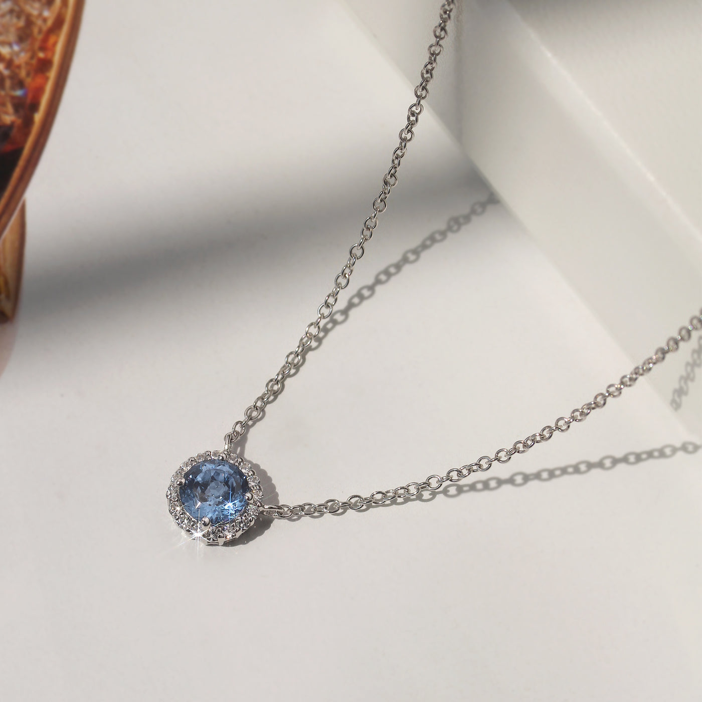 Gratitude Halo Necklace — sterling silver halo pendant with 1.2 carat CZ center, available in blue topaz