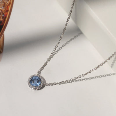 Gratitude Halo Necklace — sterling silver halo pendant with 1.2 carat CZ center, available in blue topaz