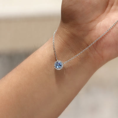 Gratitude Halo Necklace — sterling silver halo pendant with 1.2 carat CZ center, available in blue topaz tone