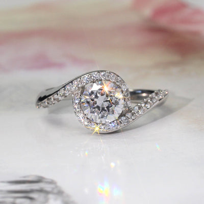 Close-up of halo setting and soft silver curve.