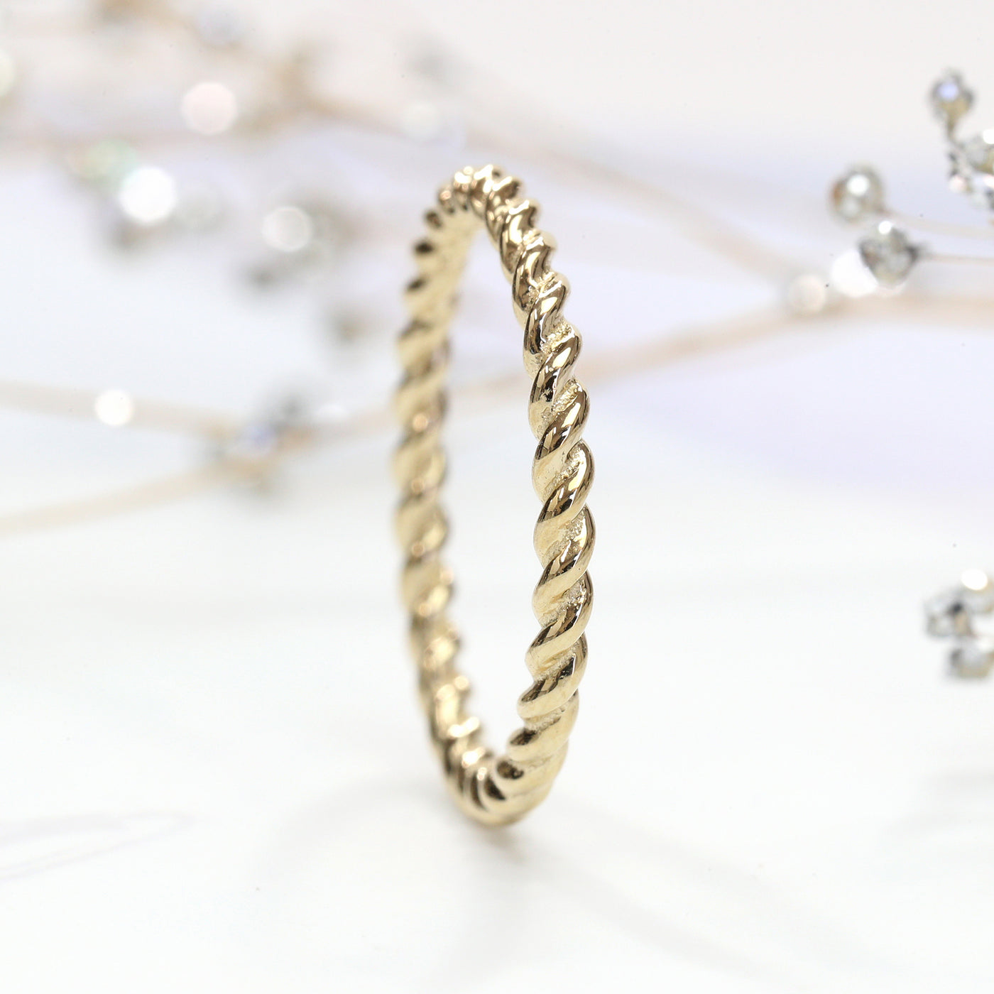 Thin 14K gold twisted rope stackable ring close-up