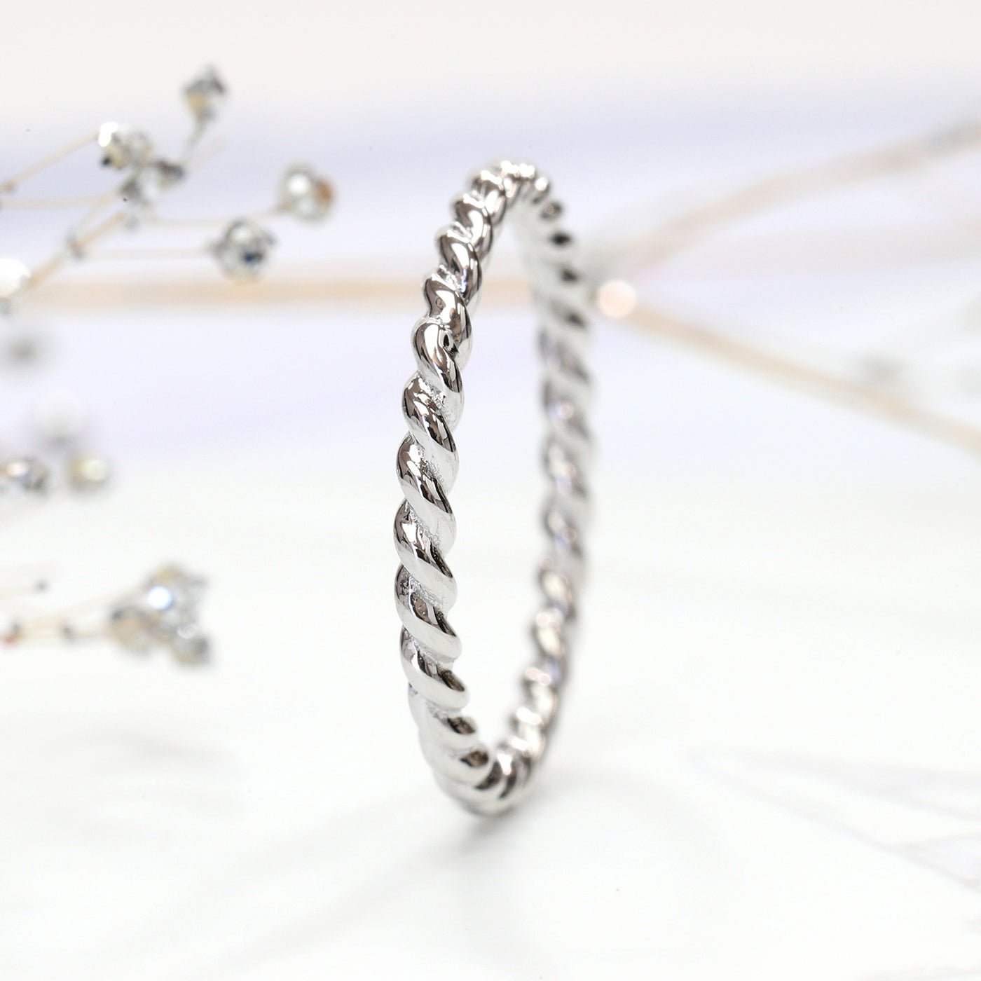 Thin 14K white gold twisted rope stackable ring close-up