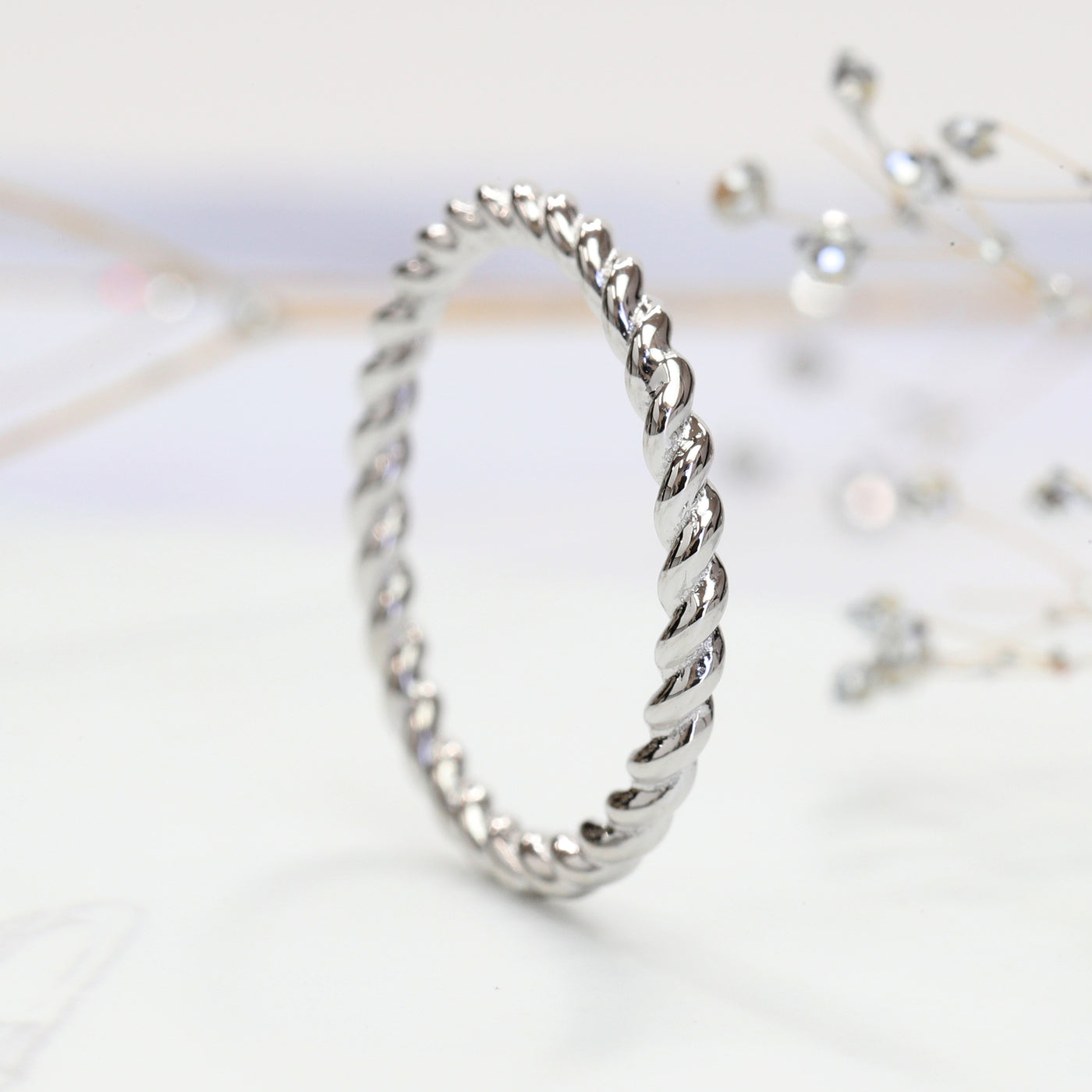 Thin 14K white gold twisted rope stackable ring close-up