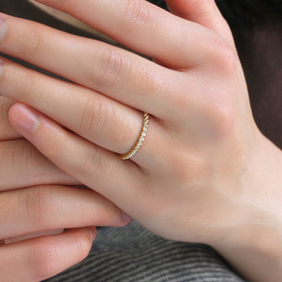 Delicate rope gold ring worn alone on finger