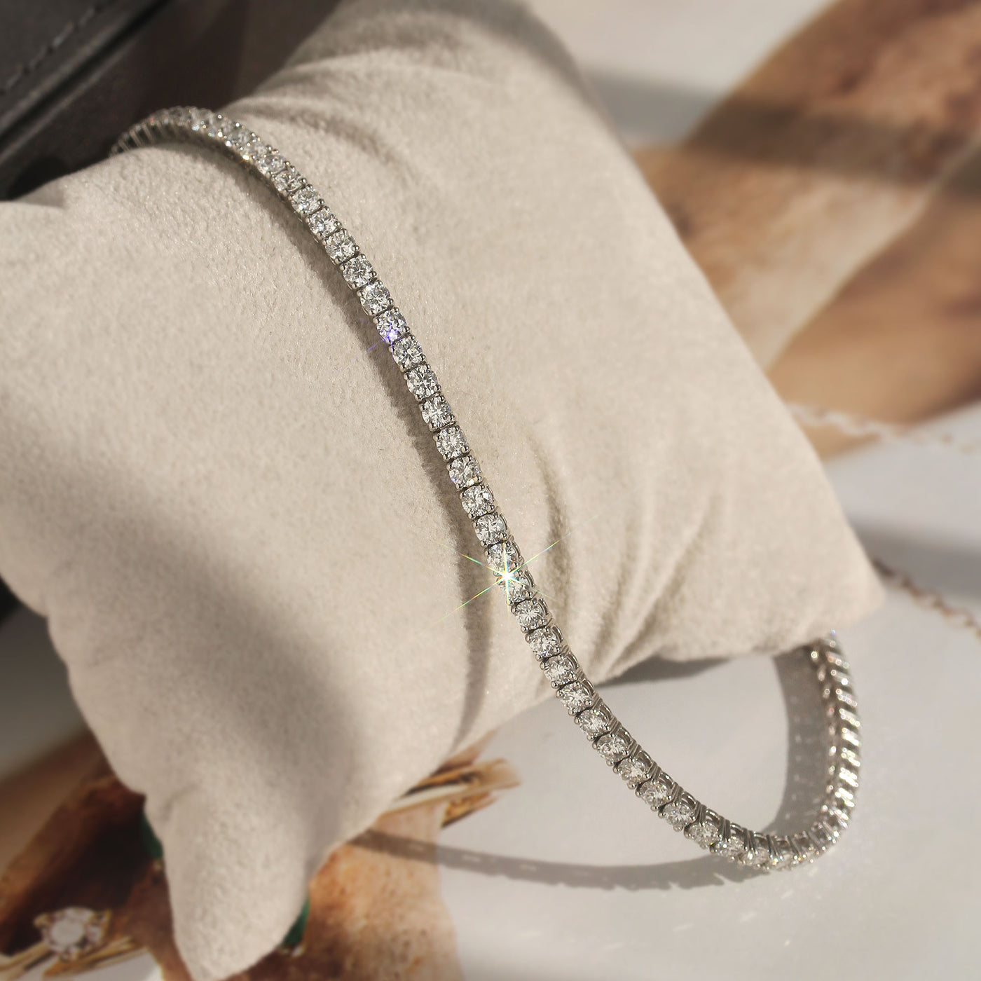 Inner Radiance Tennis Bracelet in platinum-plated silver with moissanite, flat view.